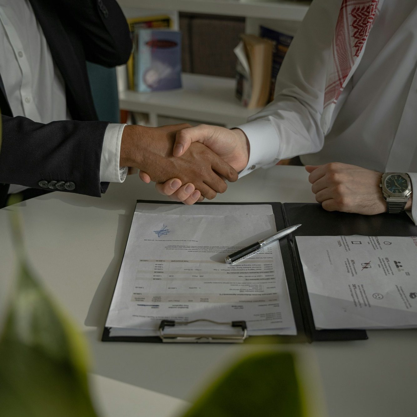 Building trusted advisory partnerships Business advisor shaking hands with client representing trusted strategic advisory partnership and consulting relationship with Hayes & Co