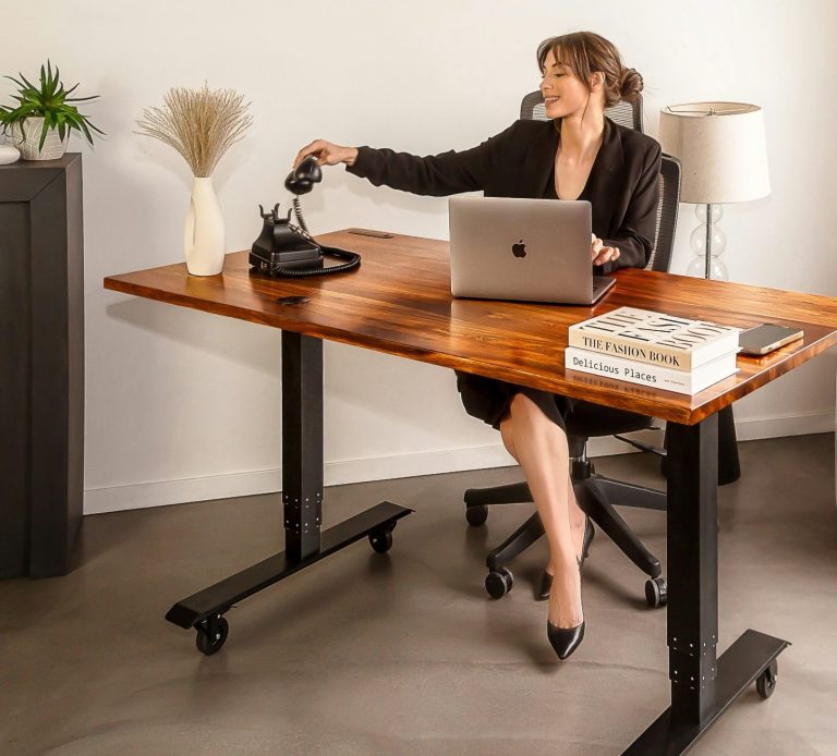 Payroll & HR made simple for small businesses Business manager processing payroll at desk representing small businesses using Hayes & Co payroll PAYE and RTI services in East London