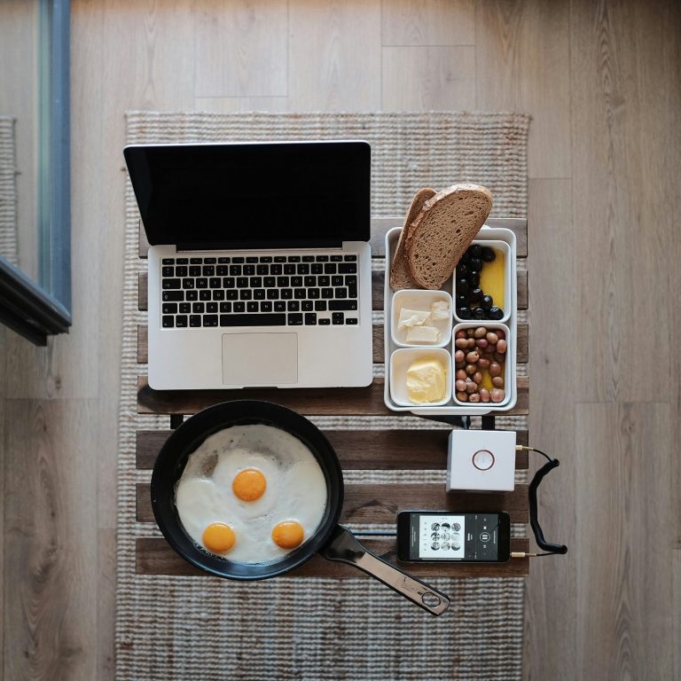 Work from anywhere, we handle your taxes Freelancer laptop and breakfast workspace representing flexible self-employed lifestyle supported by Hayes & Co accounting in East London