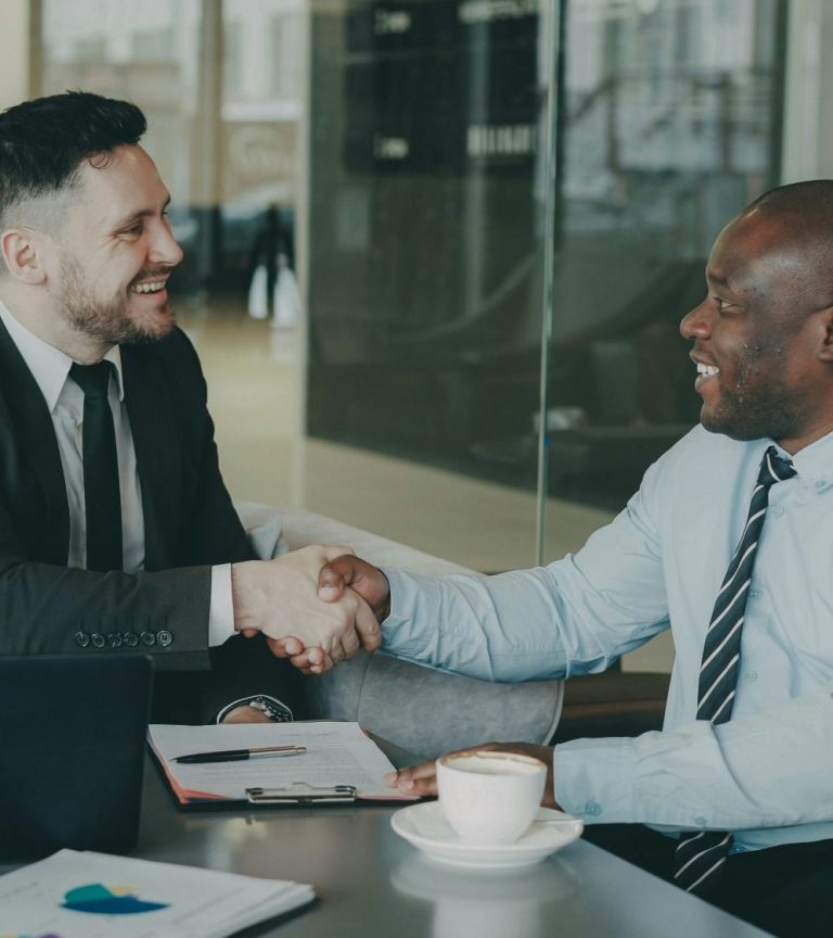 Capital Services Hayes & CO professionals shaking hands in a modern office setting.